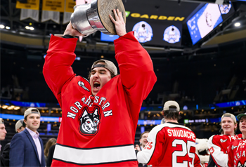 Men's hockey player holding the Beanpot trophy Men's hockey player holding the Beanpot trophy